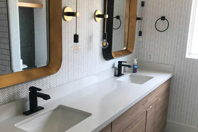 Double vanity in timber with black tapware and twin framed mirrors