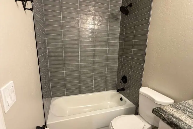 Bathtub with a full tile surround in a finished bathroom