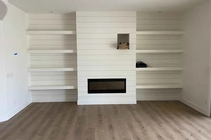 Shiplap fireplace wall with a linear gas insert and built-in shelving