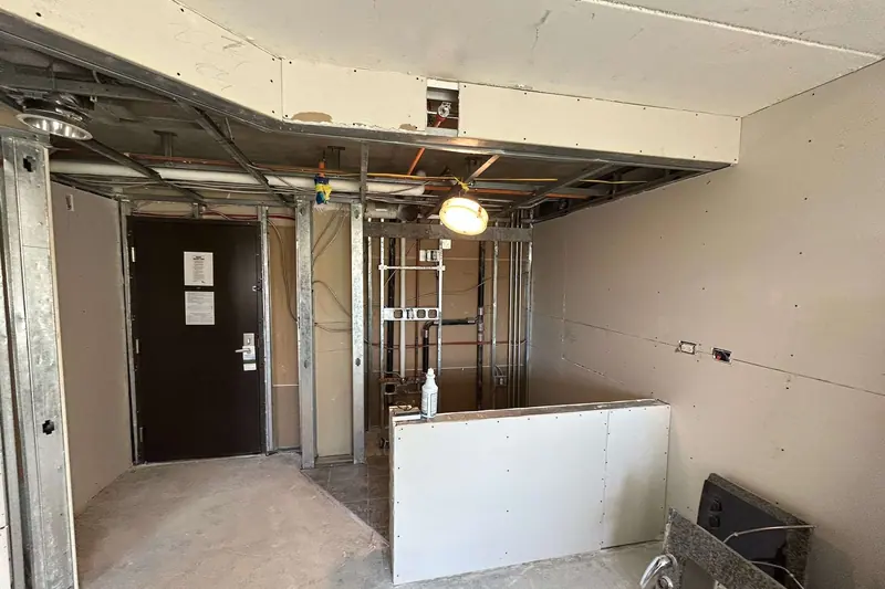 Interior taken back to framing with new drywall going up around a doorway