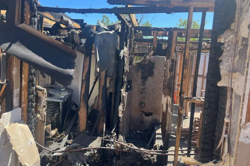 Charred roof framing exposed after a house fire