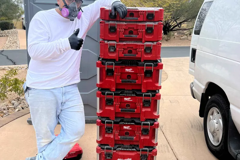 A Restored technician in a respirator and gloves with sealed containment equipment on site